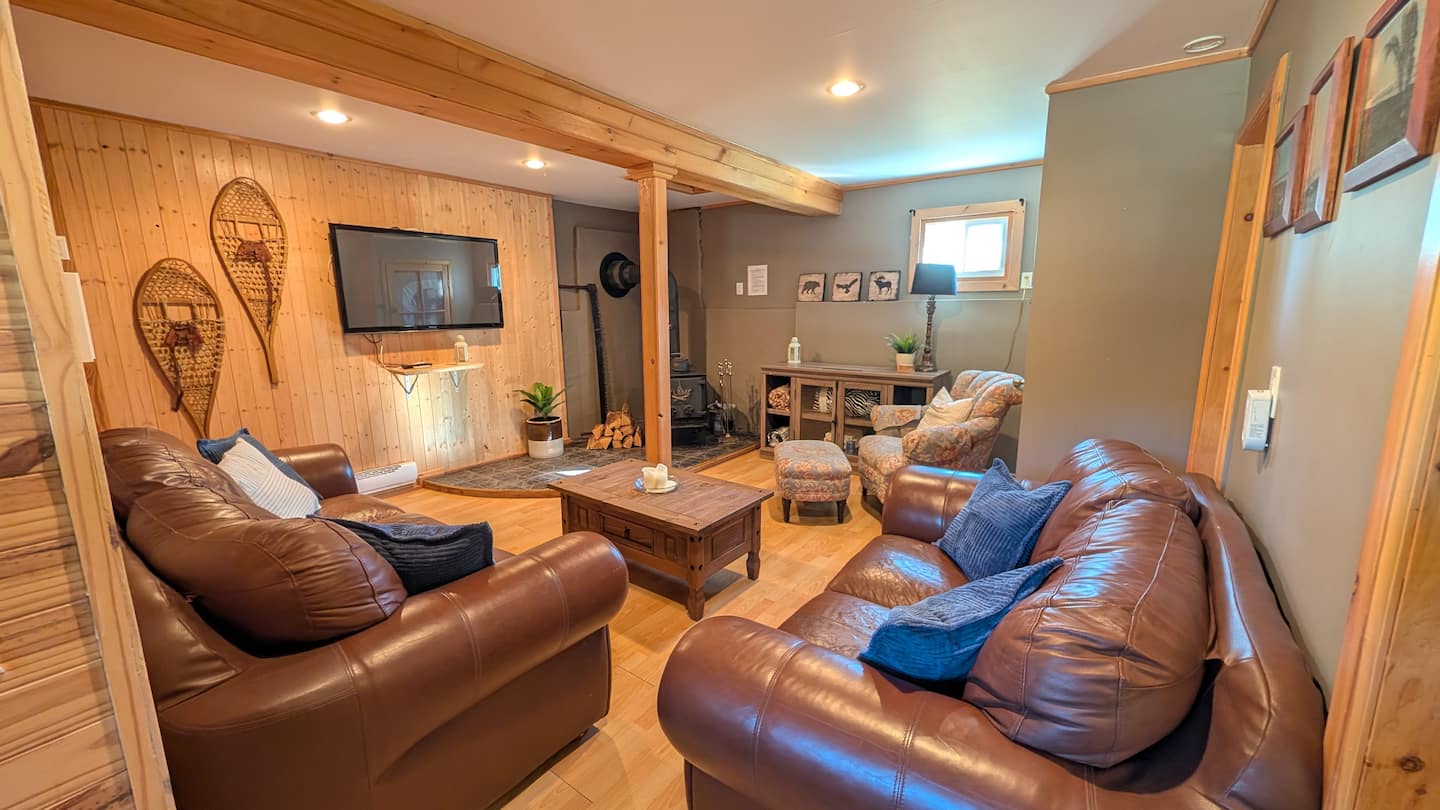 Living room with leather sofas and wood stove